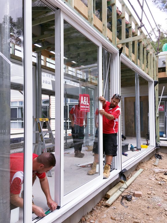 A&L team members installing Boutique Sliding Doors.