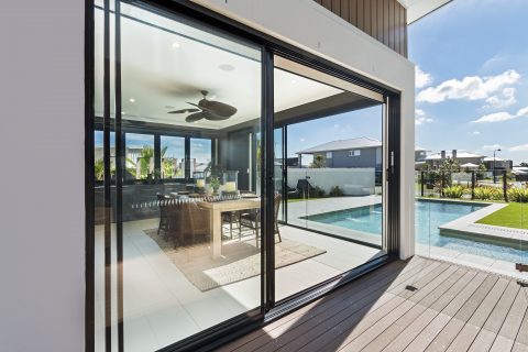 an image of a modern house showing the kitchen, large aluminium sliding doors are featured