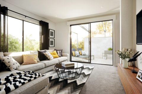A lounge room setting, showing a couch and aluminium sliding doors