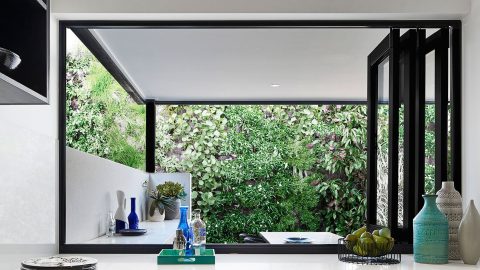 a new kitchen with a folding window joining with an outdoor living area